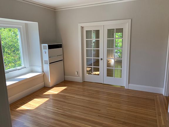 Living Room with Wall Heater - interior French Doors into Bedroom (B)