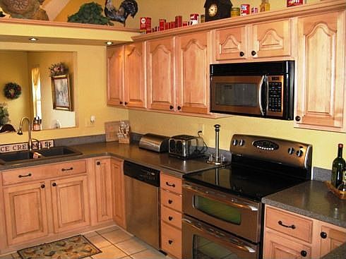 Updated kitchen with maple cabinets, corian countertops