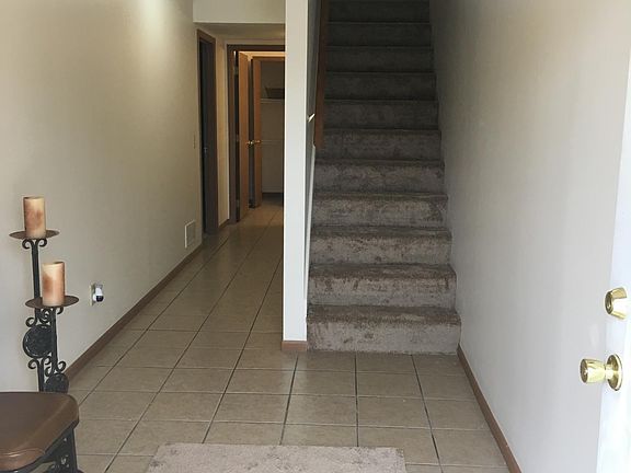 Ground level front entry way leads upstairs to main living area. Bed, bath and washer dryer hook up at the end of the hallway.