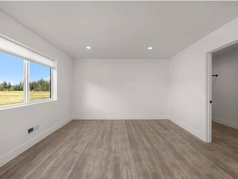 Spacious walk-in closet conveniently located within the suite, offering ample storage and organization space