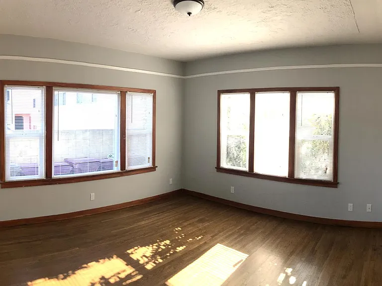 View of the main room - classic hardwood floors, high ceilings, lots of natural light!