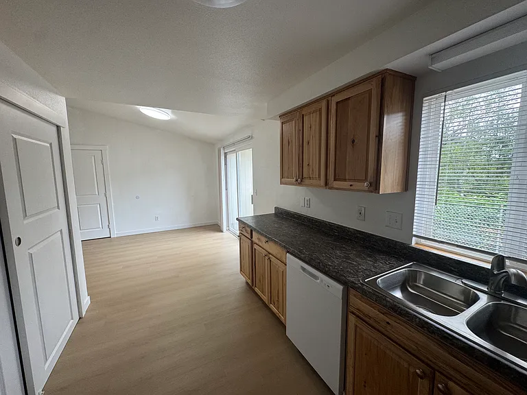Open-concept kitchen with abundant cabinetry, generous counter space, and a seamless flow into the bright living area.