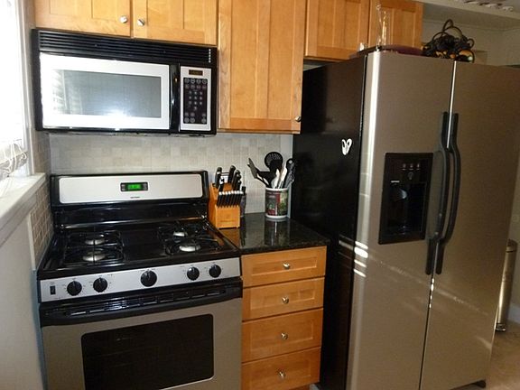 Very spacious kitchen, with stainless steel appliances (all remain), maple 42" cabinets, granite counter tops, additional storage above on both sides of kitchen provides ample space for platters, barware, etc.