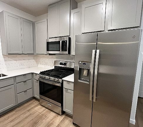 Modern Stainless Steel appliances including a gas range stove