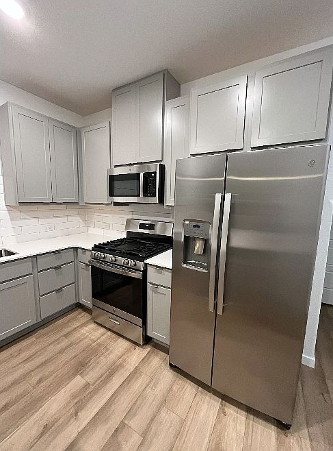 Modern Stainless Steel appliances including a gas range stove