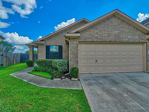Two Car Attached Garage.  Curved sidewalk leads you to the front entry of the home.