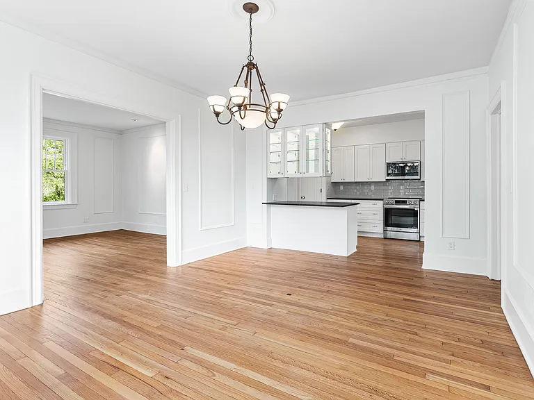 Formal dining, with view of kitchen and living room