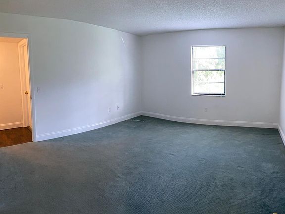 The spacious master bedroom is spacious and recently painted.