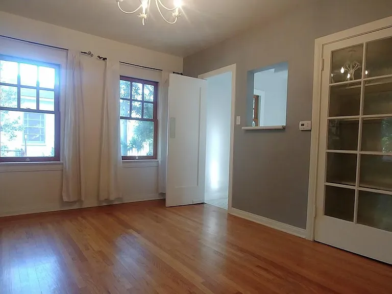 Dinning Room with newly refinished floors and built in storage cabinet.