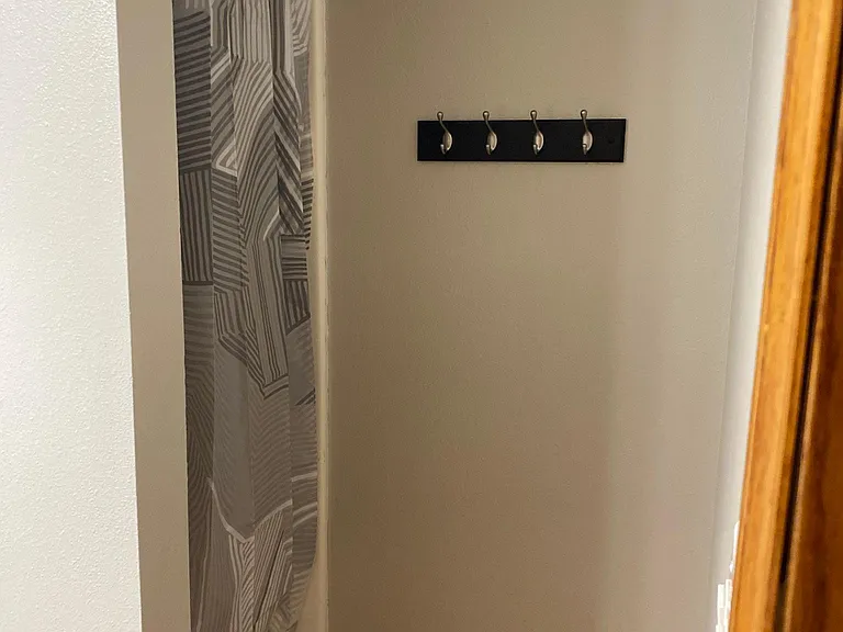 The 2nd bathroom has a walk in shower and shares the space with the laundry closet with customized wire shelving.