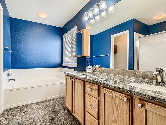 Primary bath with granite and shower, also large soaking tub