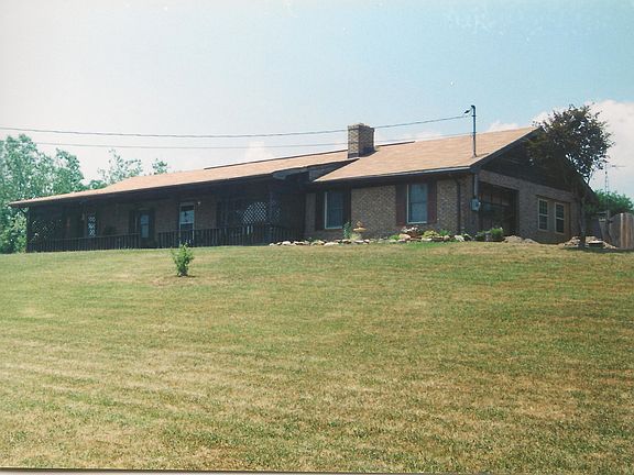 Tenant would need to acquire mowing services for 1 1/3 acres or do the mowing themselves-Long Gravel Driveway shared with neighbors- House had its own BIG parking area. This is an old picture- French doors are now on the end of house which was renovated