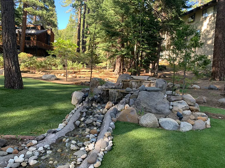 Tranquil backyard pond with a cascading waterfall _ the perfect spot to relax and unwind in your own private oasis.