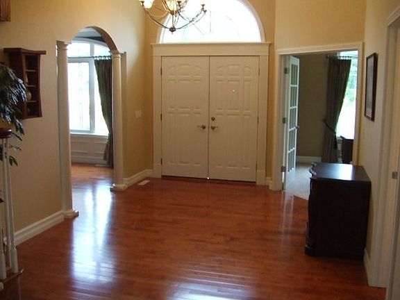 Hardwood flooring, graceful archways, columns and detailed crown molding 
