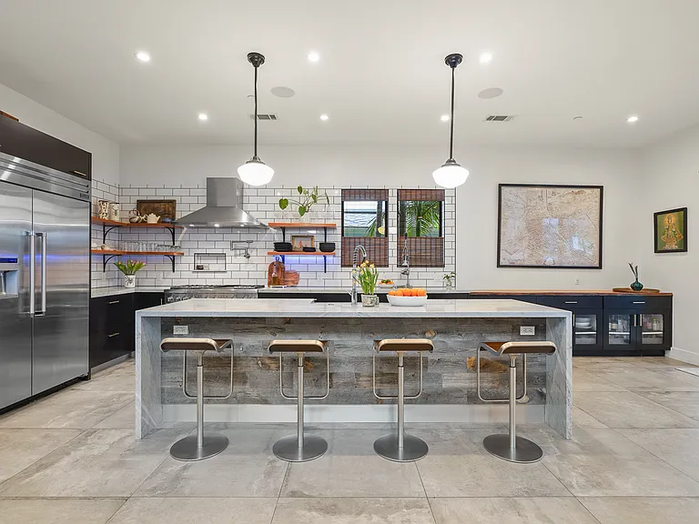 Kitchen features top of the line appliances including a six-burner stove with dual ovens