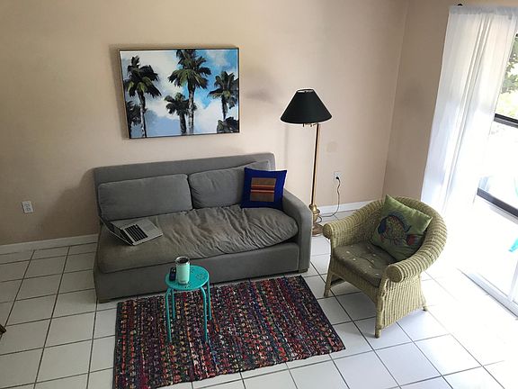 Living room overlooks front yard and patio.