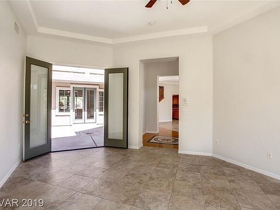 Formal Living Room off Entry Foyer (with wood floor and beautiful tile medallion).  Double doors open to interior courtyard with fireplace accessible from Living Room, Dining Room and Family Room.