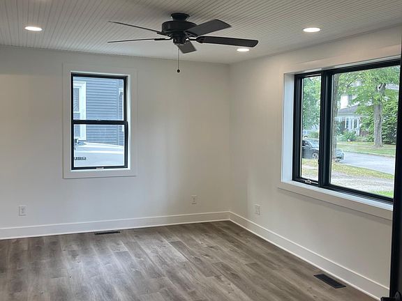 The master bedroom windows allow lots of natural light with a view of the front yard.