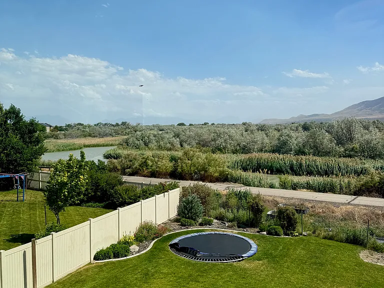 All bedrooms have views of the mountains, river, trampoline and basketball court. Jordan River Parkway Trail is directly behind the house