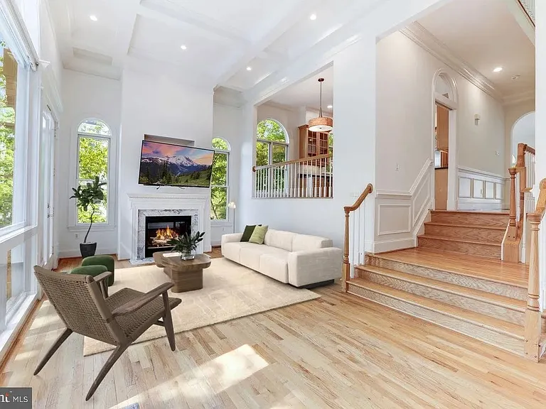 Main level family room with a wall of windows that look out onto a large deck.