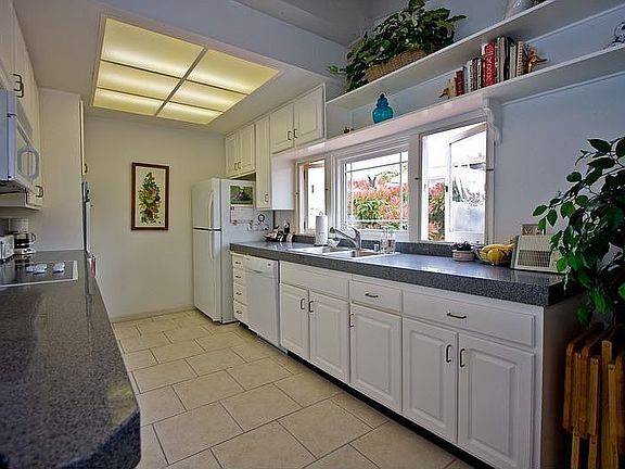 Remodeled kitchen with granite counters.