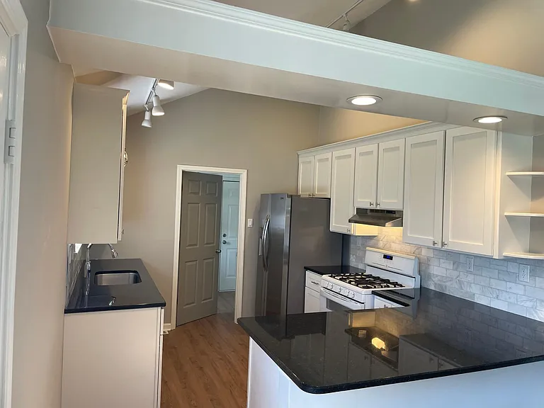 Kitchen looking toward laundry and garage door