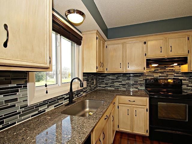 Wow! Completely updated kitchen with granite countertops, glass tile back splash, new lighting and floors!