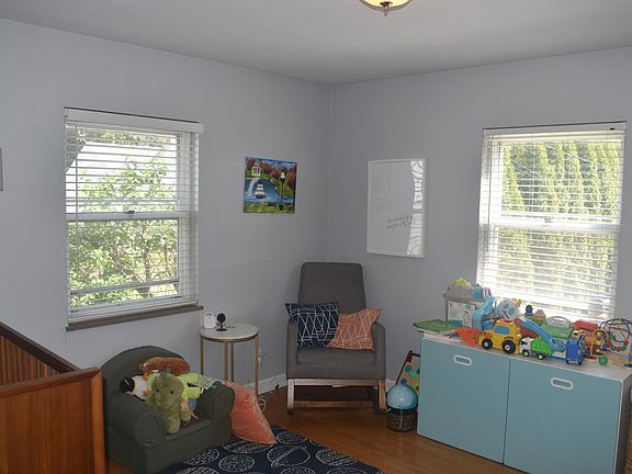 Main floor bedroom 1, windows facing the side and back of the house.