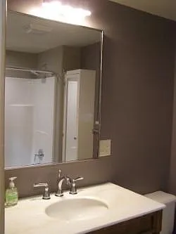 Bathroom large stylish mirror and marble vanity top.