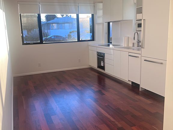 Great room with kitchen built-ins. Microwave, oven, dishwasher, refrigerator with clean lines, efficient workflow.