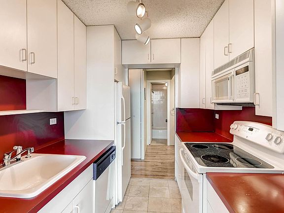 Tons of storage space in kitchen with tile floor.