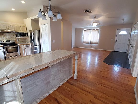View of central living space from the back door. Lots of counter space for eat-in kitchen dining.