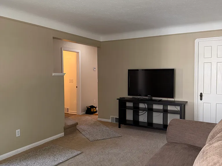 Living Room leading to full bath and two first-floor bedrooms