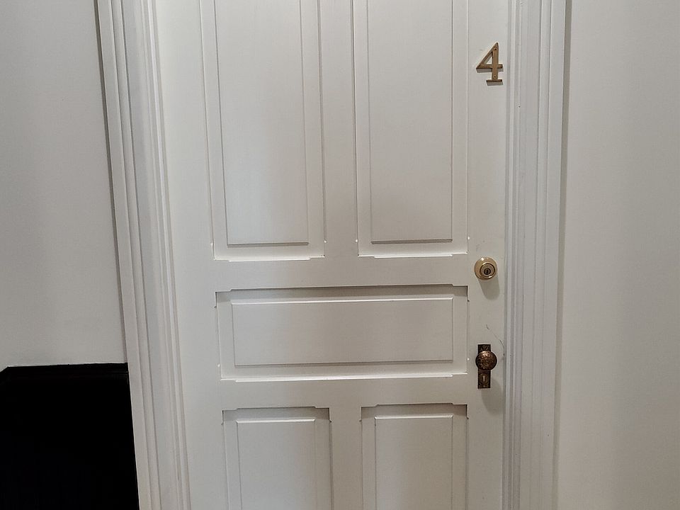 Main door to Apartment 4 from the 3rd floor communal hallway.