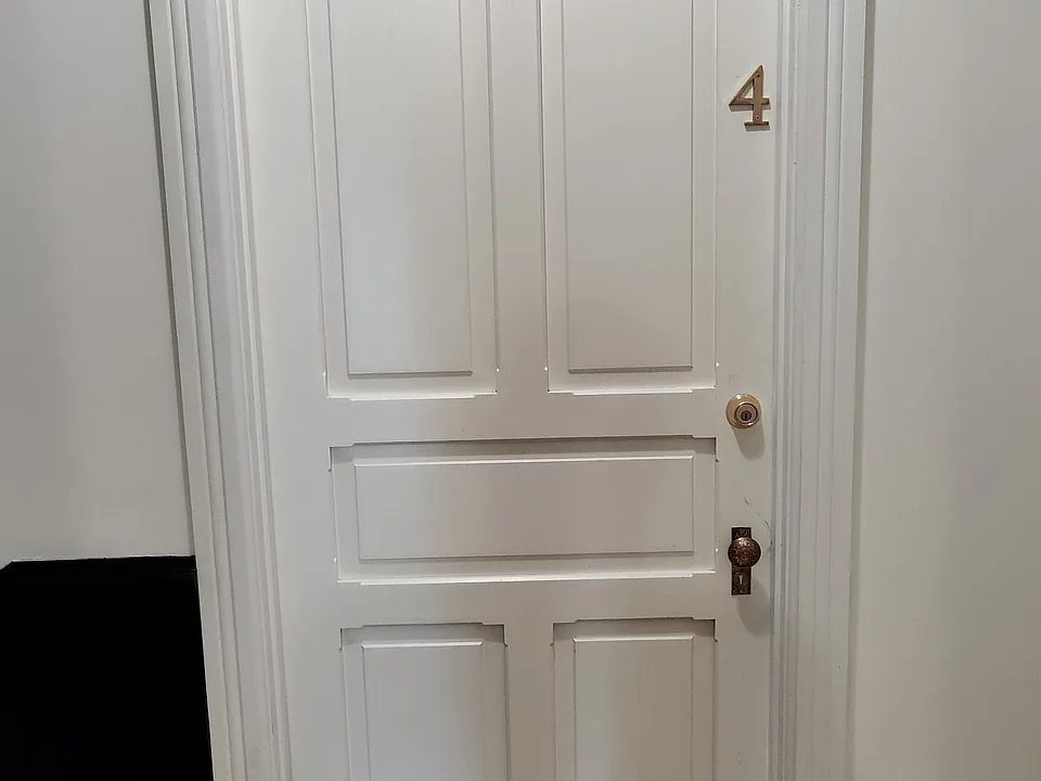 Main door to Apartment 4 from the 3rd floor communal hallway.