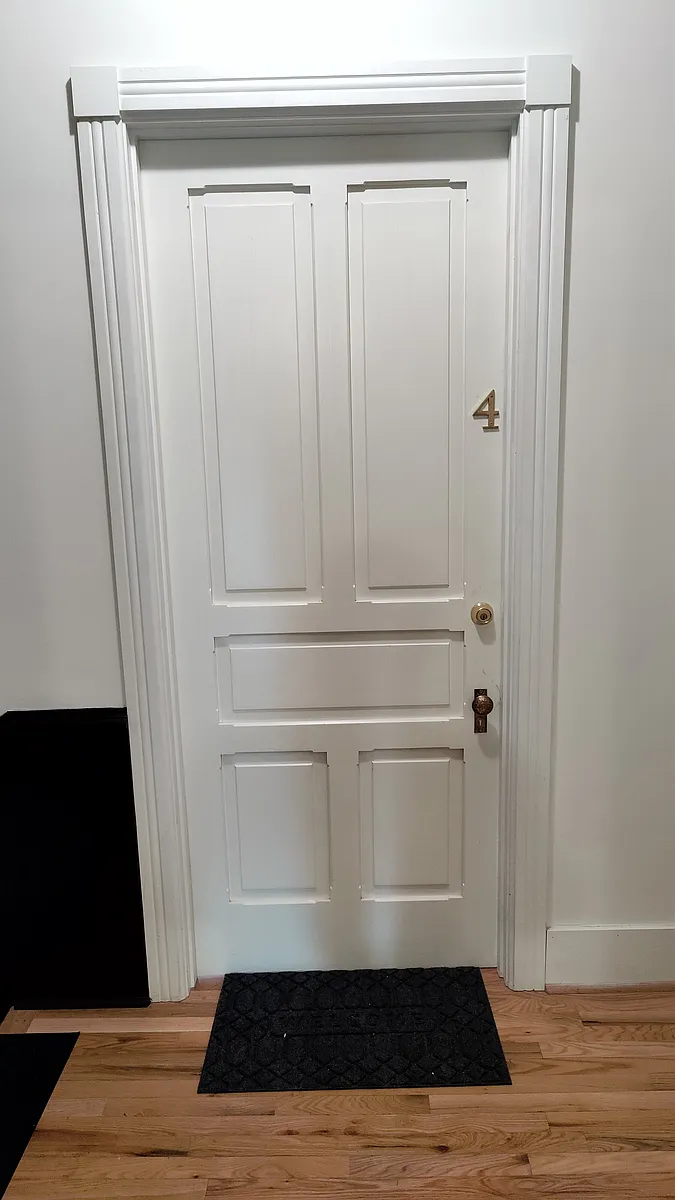 Main door to Apartment 4 from the 3rd floor communal hallway. - 1118 S 3rd St #4