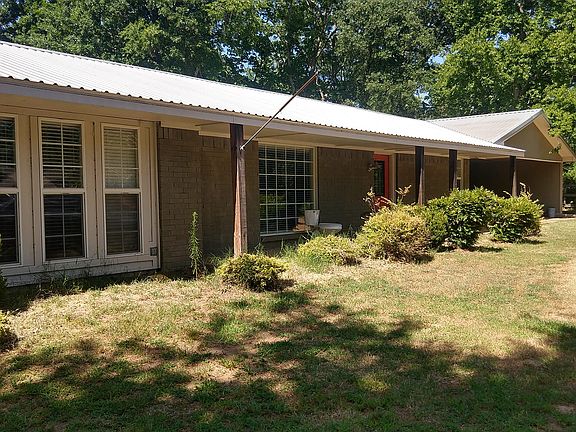 Front of House with attached storage building and 2 car covered Breezeway