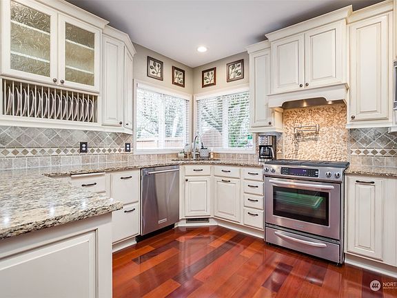 Classy white kitchen; note the pot-filler over the gas stove!>