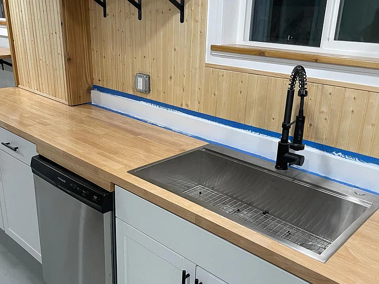Large stainless steel sink with restaurant spray faucet and brand new stainless dishwasher