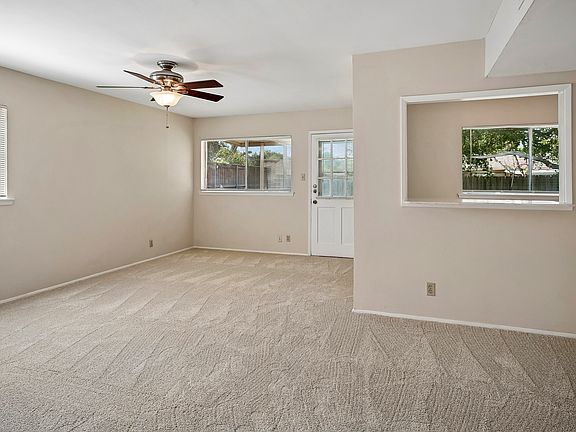 Den with bar opening to the kitchen and door to the backyard. All carpet is freshly installed.