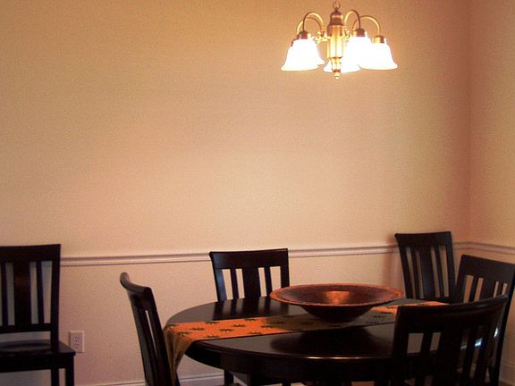Formal Dining Room with wood floors, chair railing