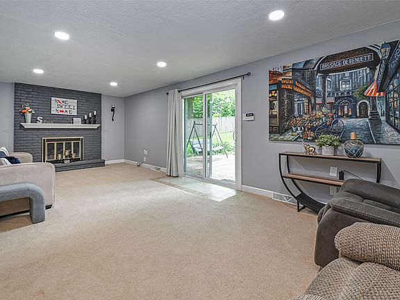 Main level family room with cozy gas log fireplace.