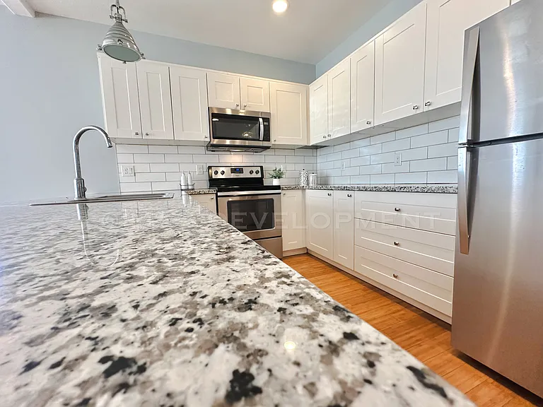 Kitchen island-granite surface. Stainless Steel Appliances. Bamboo flooring.