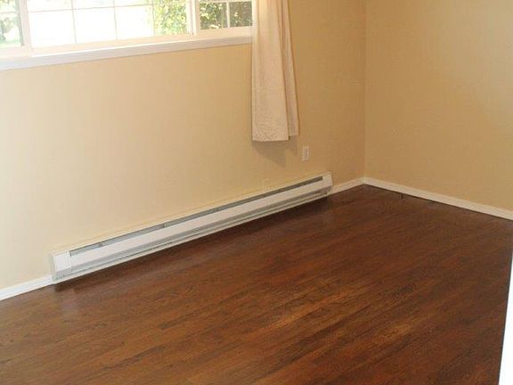 Larger main bedroom with oak hardwood flooring