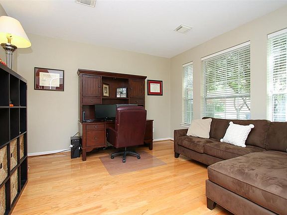 The study is brightly lit from the wall of windows.