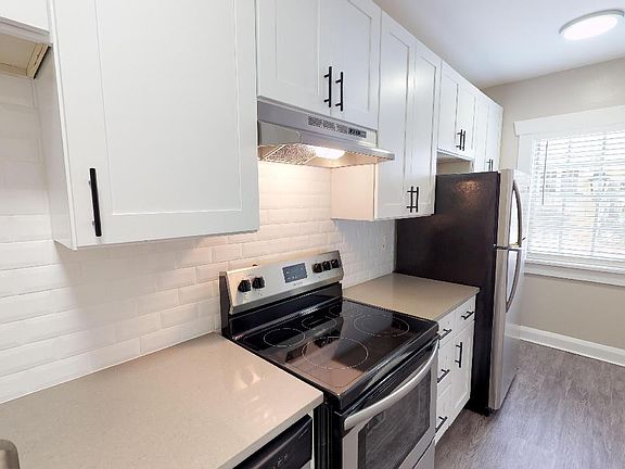 Studio kitchen with quartz countertops and LED brushed nickel light fixtures