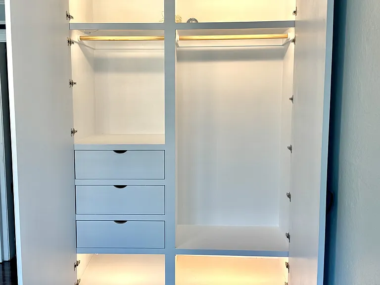 New custom oversized closet with double hanging section, upper shelf, deep drawers, shoe shelf, and motion lighting.
