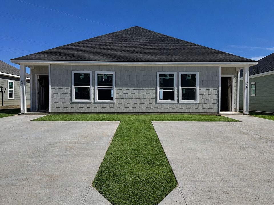 Brand-new 2BR/2BA duplex with private driveway and modern exterior.