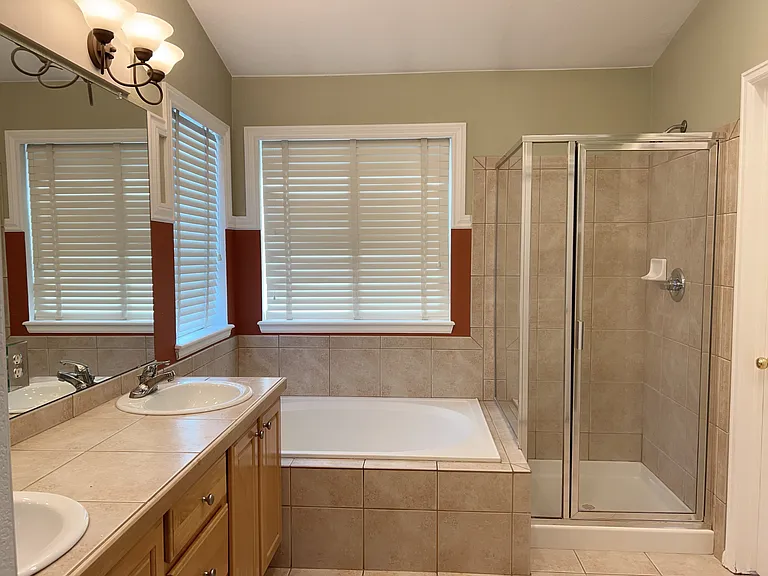 Master bath - 5 piece suite with vanity sinks, garden bathtub, walk-in shower and rest room