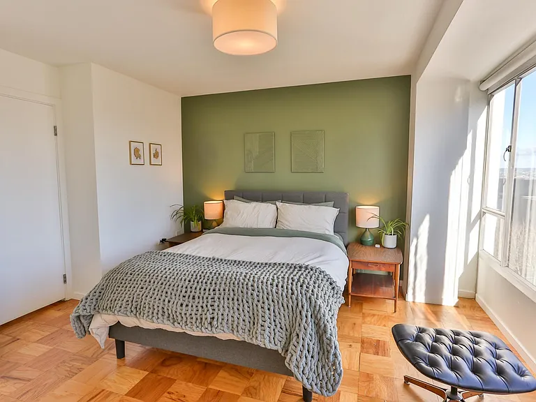 A open and cozy bedroom with views over first hill park.